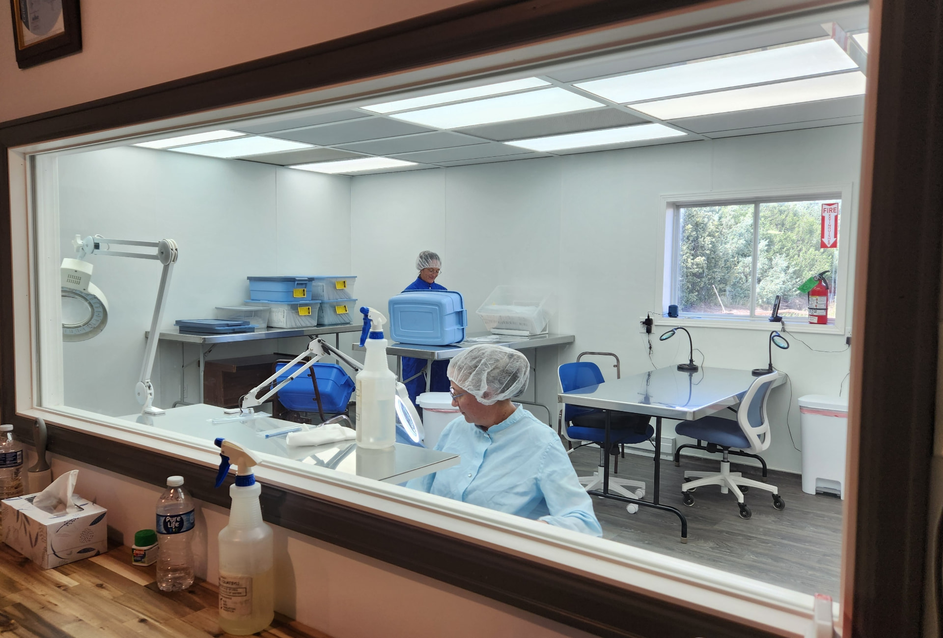 CMI technicians working inside the ISO Class 7 cleanroom